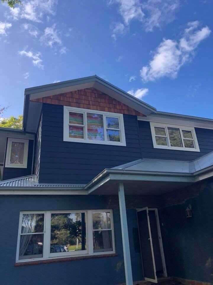 Two-storey weatherboard, Navy blue cladding, by Luxe Effects
