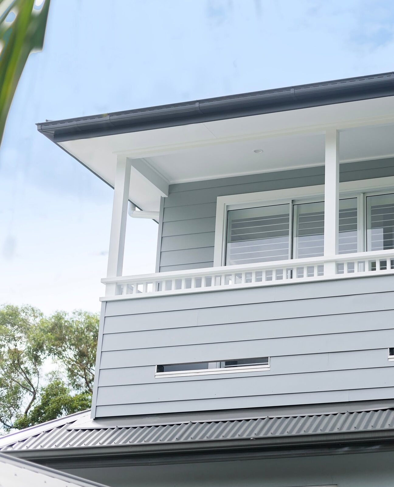 Coastal grey weatherboard home with crisp white trim, painted by Luxe Effects